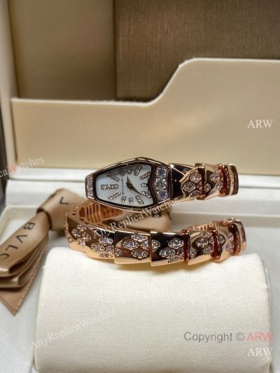 High Quality Replica BVLGARI Serpentine-Spiga K Gold With Zircon-Inlaid Strap Natural Mother-of-Pearl With Black Enamel Face Dial 316 Stainless Steel Case Watch